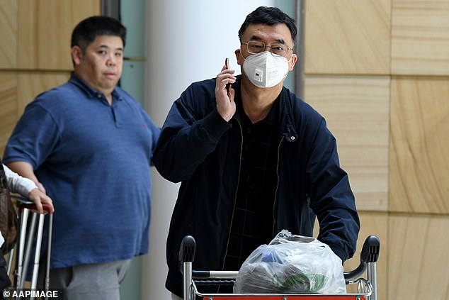 A passenger wearing a protective masks on arrival at Sydney International Airport in Sydney, Thursday, January 23